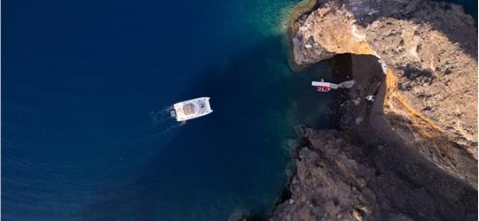 Photo of Private Power Catamaran Cruise in Santorini with BBQ and Drinks