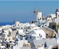 Why are most houses white painted in Santorini?