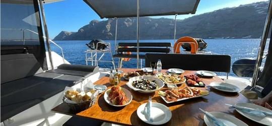 Photo of Scenic Catamaran Trip around Santorini with BBQ and Beverages